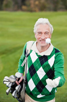 Italy, Kastelruth, Mature man playing with golf ball
