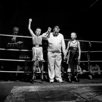 Referee Holds Up Enthusiastic Eleven Year Old Boy\'S Hand, Declaring Him Winner Of The Boxing Match