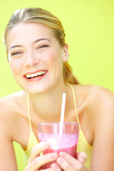 Woman Having Smoothie Smiling