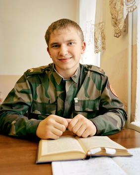 A Young Russian Student In Army Attire Sits Behind His Desk In The Classroom At The Krasnoyarsk Military Cadet School In Eastern Siberia.