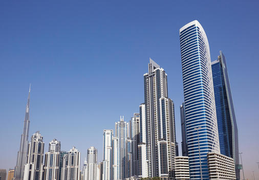Modern architecture alongside \'Khalifa Bin Zayed The First street\' against blue sky in Abu Dhabi