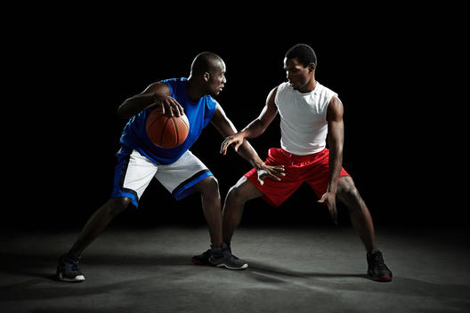 Basketball players competing for ball