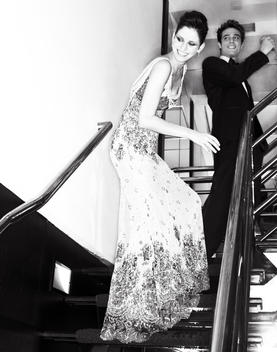 A elegant couple on a beautiful stairway.