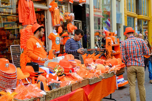 Vendors sell souvenirs and clothing in orange, the Dutch national color, for King\'s Day. Former Queen\'s Day.
