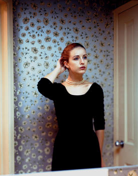 woman, 1950s, wallpaper, dressing room, bathroom, mirror, black dress, thinking, staring