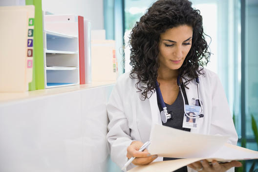 Female doctor analyzing medical records
