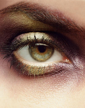 Close Up Eye With Gold And Purple Metallic Make-Up