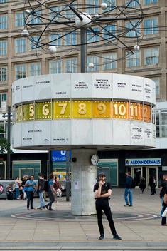 Man standing by the World Clock in Alexanderplatz.
