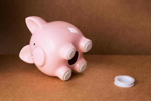 Empty piggy bank with stopper on counter