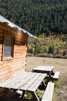Side of a cabin with picnic tables