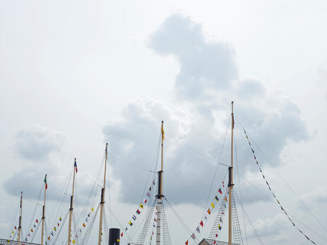 Flags fly off the mast of The Matthew boat moored in Bristol Harbour. The Matthew a replica of the English ship that discovered North America in 1497.