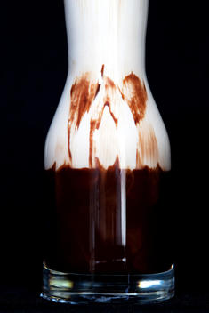 Glass Decanter Filled With Chocolate And Cream