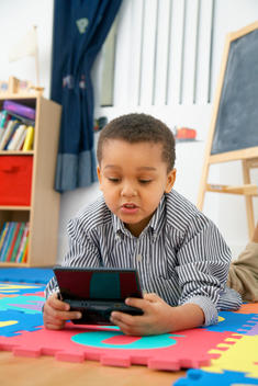 Mixed race boy playing video game