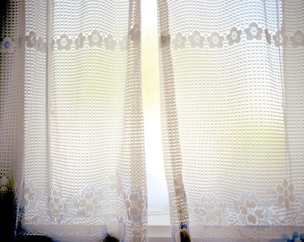 Window With Lacy Net Curtains