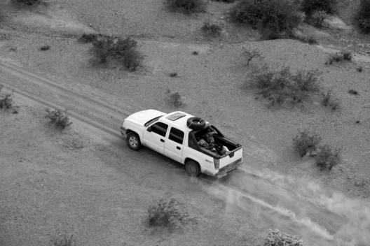 Tohno O\'odham Indian Reservation, Arizona USA August 24, 2007 Army National Guard helicopter pilot Major George Harris and another National Guard pilot spot two vehicles hidden in trees along a road that cuts illegally through an Indian reservation on wha