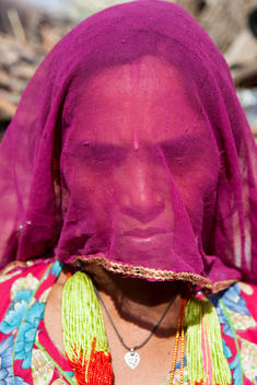 portrait of Indian woman with face covered with veil