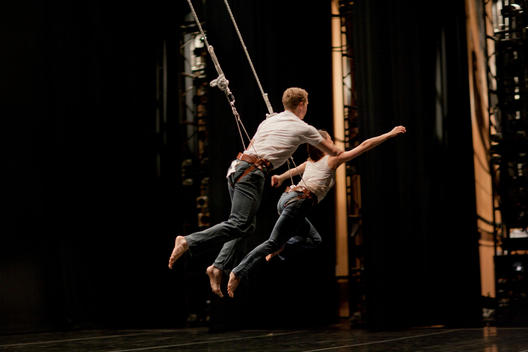 Two Dancers Perform A Piece On Stage.