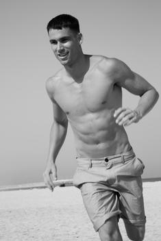 Attractive man exercising on the beach
