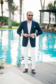 Man in suit by the pool