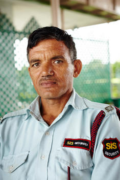A portrait of an Indian security guard.