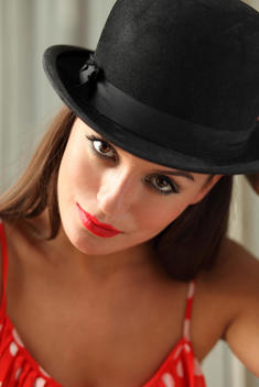 model in bowler hat and red dress