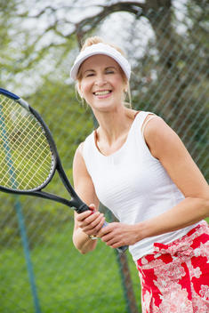 Portrait of mature woman playing tennis