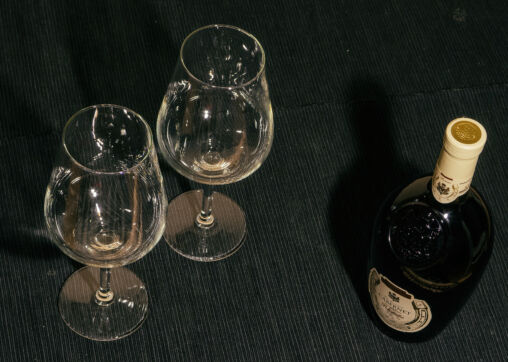 Two Glasses And Bottle Of Red Wine On Black Background