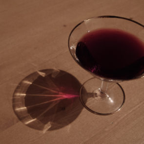 Glass of red wine on a wooden table