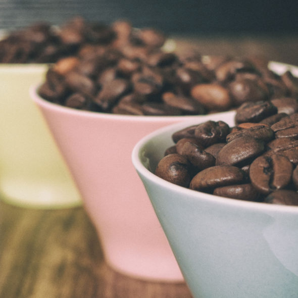Three cups with coffee beans