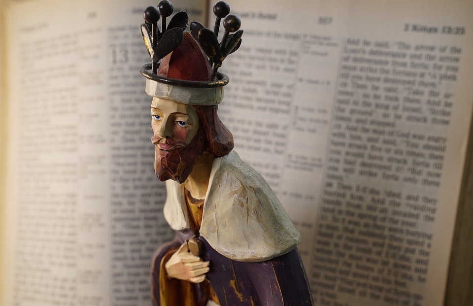 christian figurine, the king, open bible