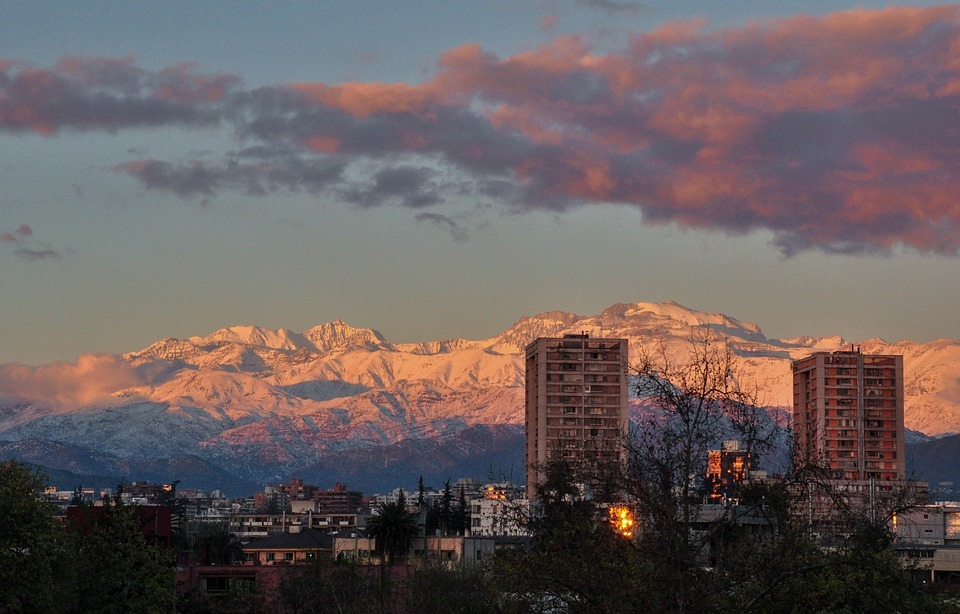 snowy mountains, city, sunset