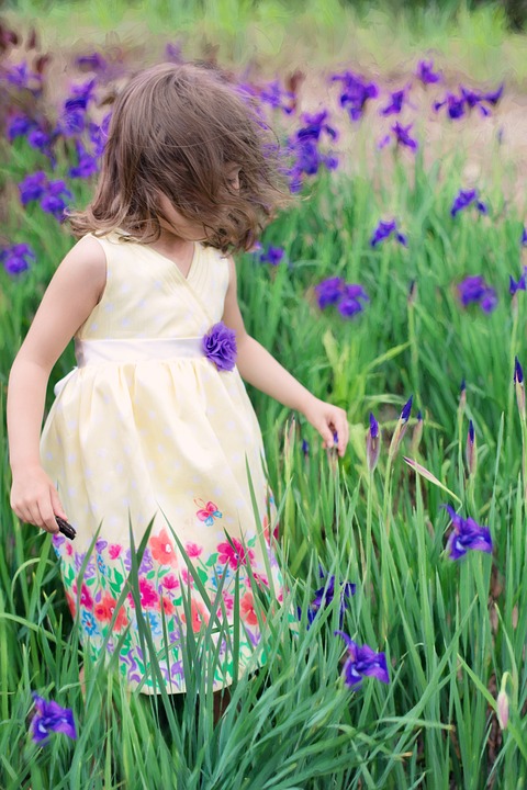 little girl in wind, summer, flowers