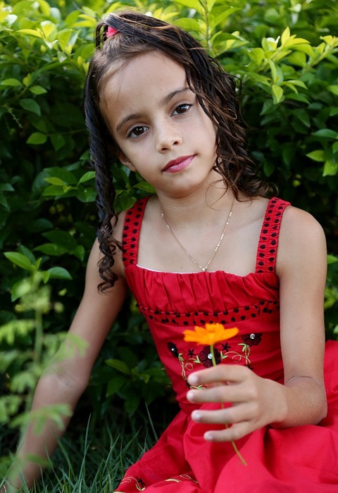 girl looking, holding flower, girl in the garden