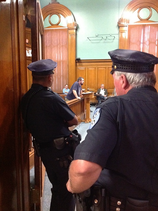 city council meeting, police officers watching, police officers