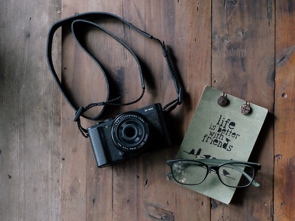 camera, notebook, glasses