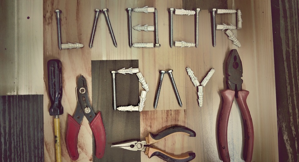 construction tools, wooden background, labor day
