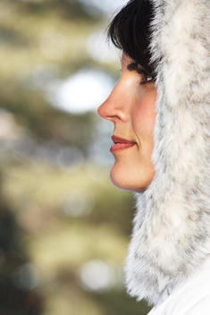 Caucasian woman wearing fur hood in snow - Stock Image - Everypixel